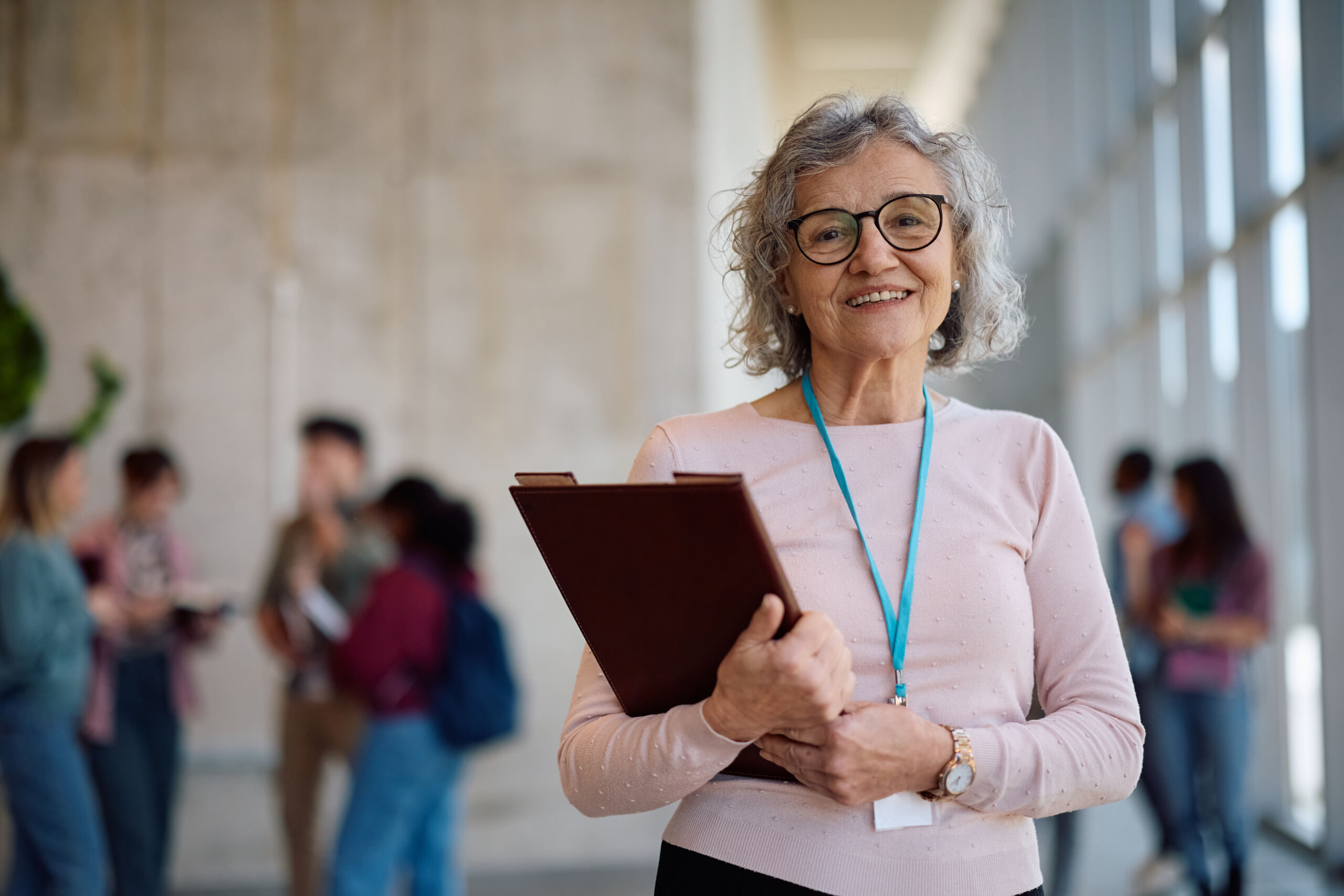 Happy mature professor at the university looking at camera.